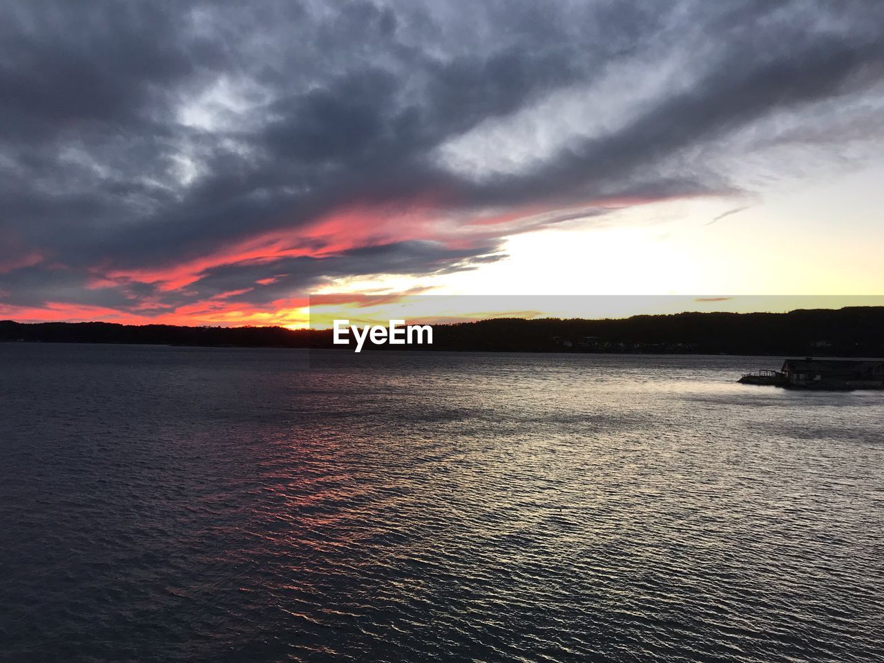 SCENIC VIEW OF SUNSET OVER SEA