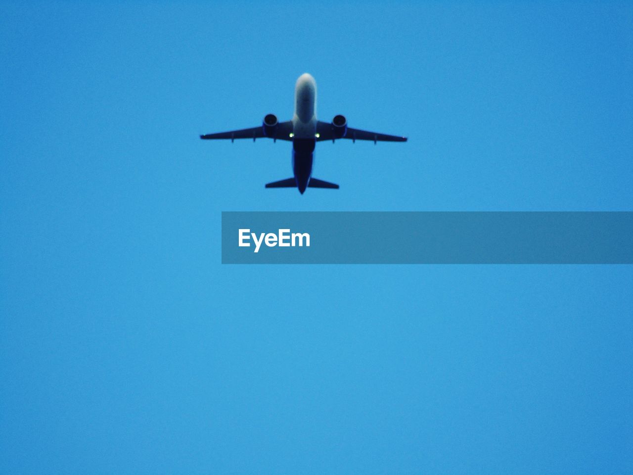 LOW ANGLE VIEW OF AIRPLANE FLYING IN SKY