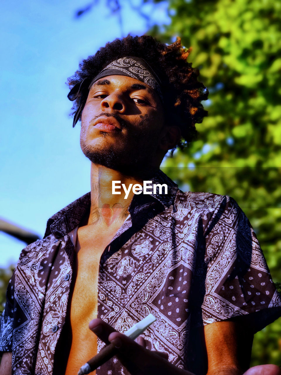 Low angle view of young man looking away