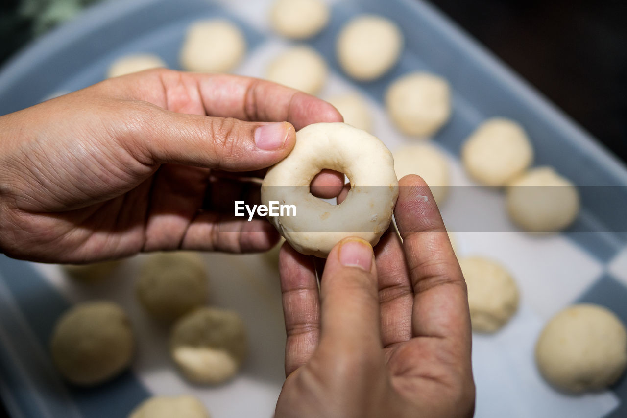 Close-up of human hands holding a cookie