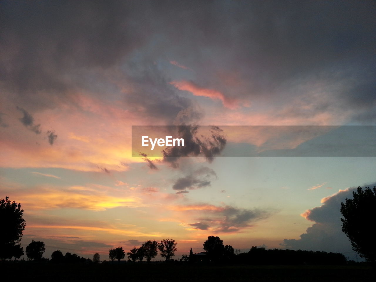 Dramatic sky over silhouette landscape