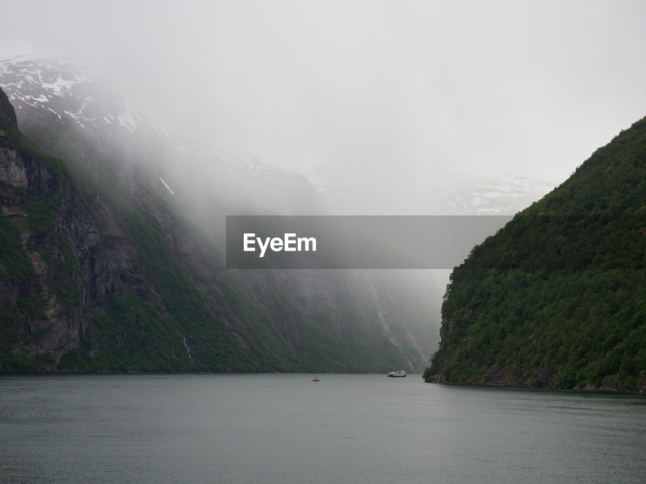 Scenic view of river amidst trees against sky