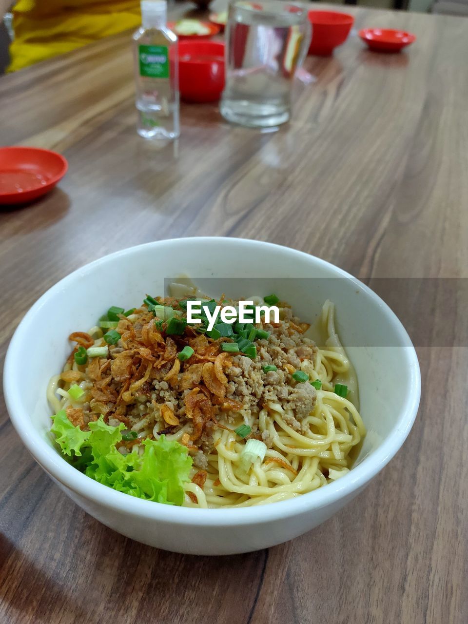 food and drink, food, table, healthy eating, pasta, italian food, dish, freshness, wood, wellbeing, cuisine, vegetable, indoors, meal, plate, bowl, thai food, no people, produce, herb, chow mein, focus on foreground, high angle view, noodle, crockery, bakmi, spaghetti, close-up, spice, lunch