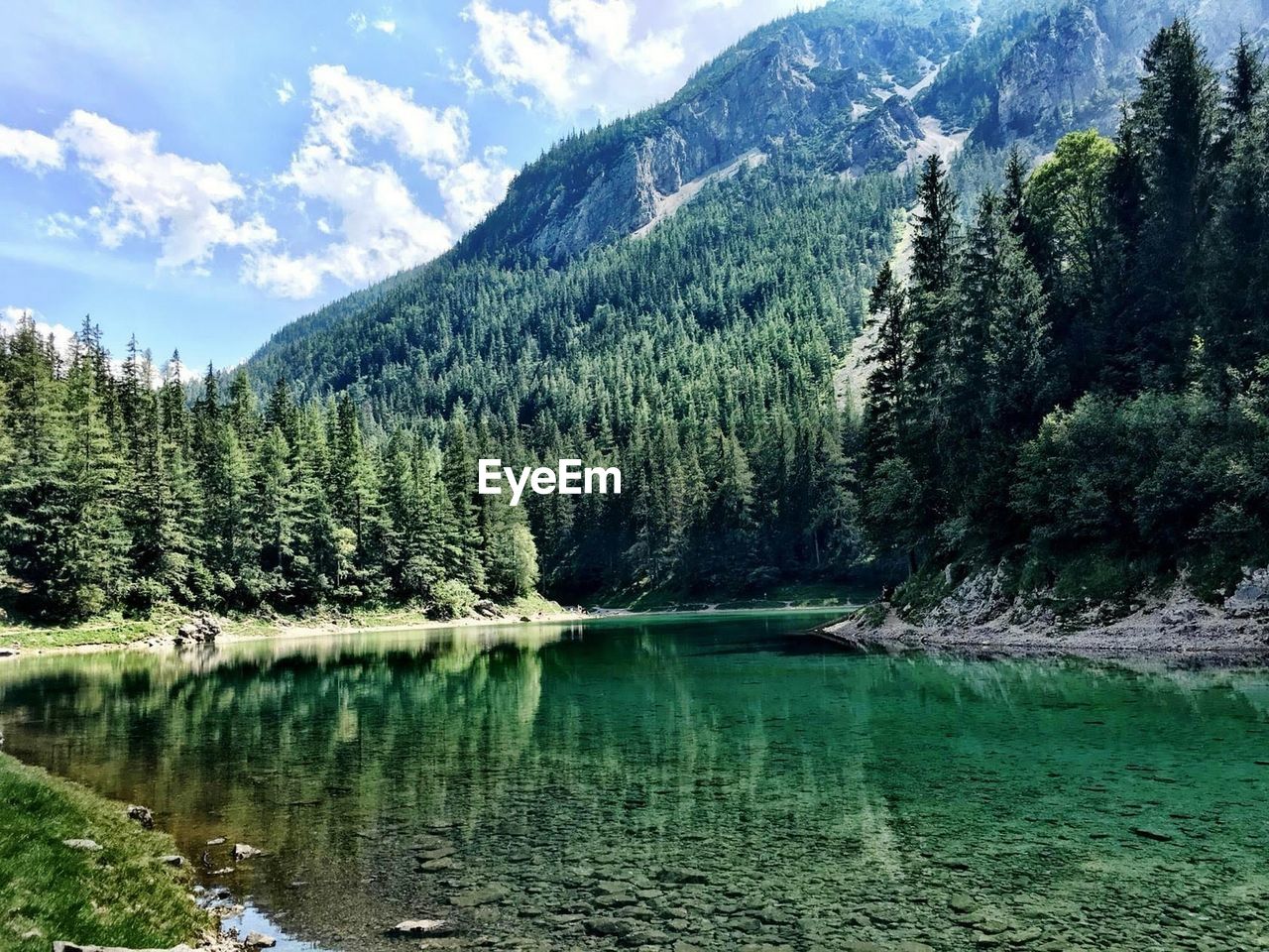 Scenic view of lake and mountains against sky