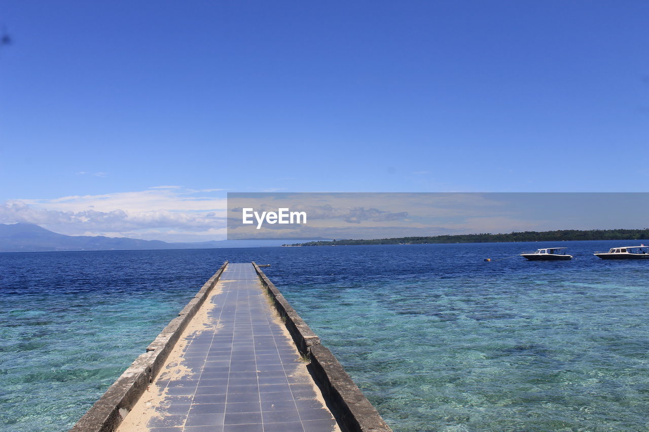 PIER AMIDST SEA AGAINST BLUE SKY