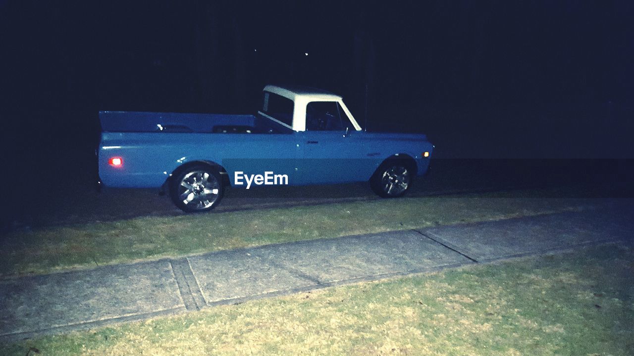 CLOSE-UP OF VINTAGE CAR AT NIGHT