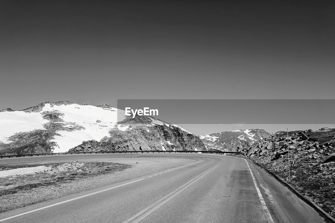 ROAD LEADING TOWARDS MOUNTAINS AGAINST SKY