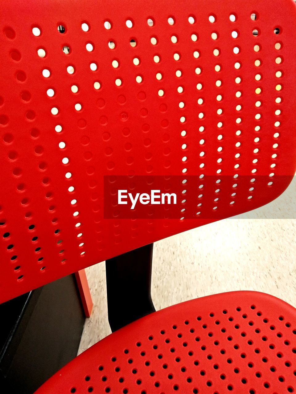 FULL FRAME SHOT OF RED CHAIR ON METAL