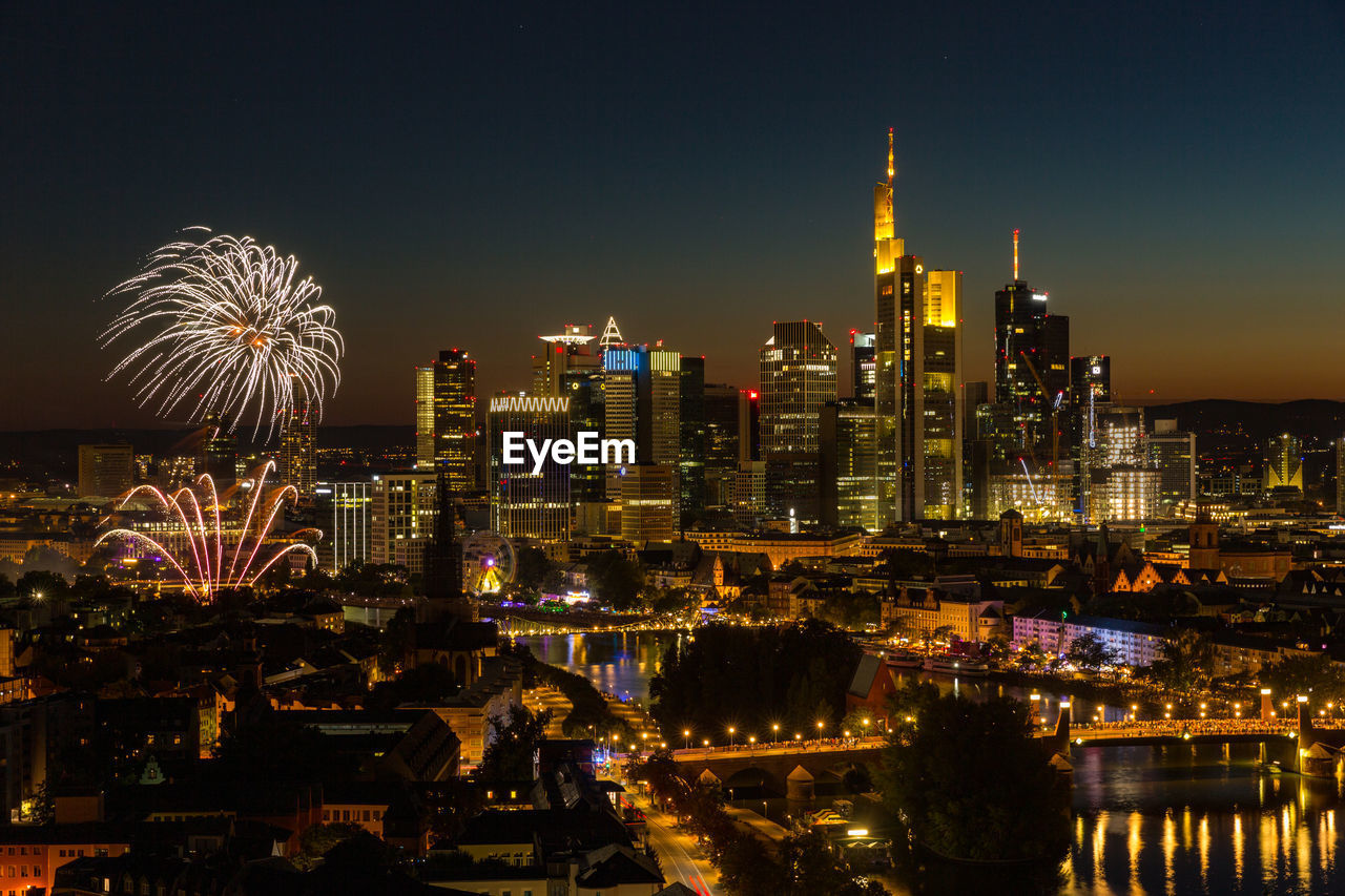 Fireworks mainfest frankfurt in front of illuminated city skyline