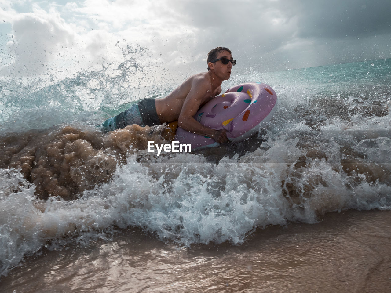 Man surfing on sea against sky