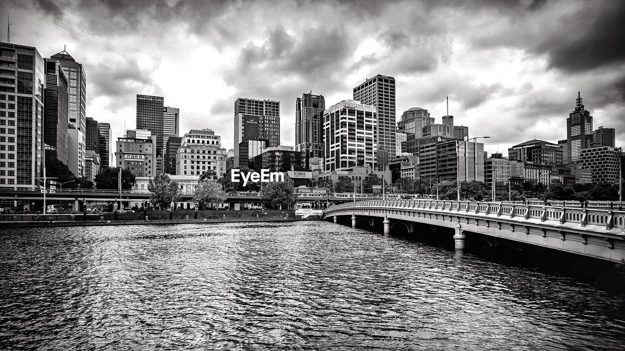 View of cityscape against cloudy sky