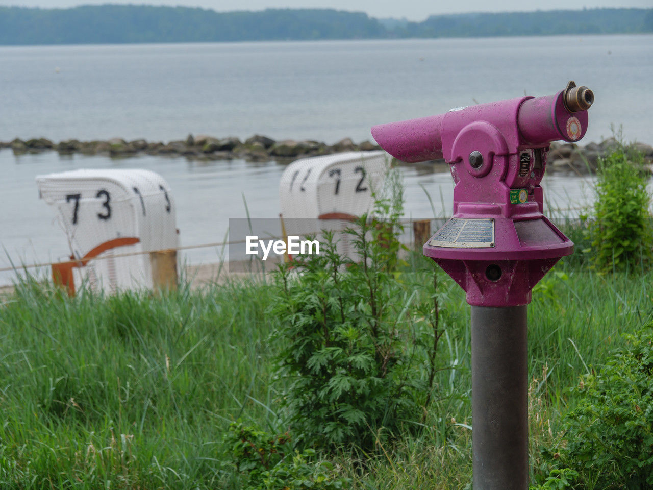 water, binoculars, nature, coin operated, plant, grass, security, coin-operated binoculars, sea, no people, day, fire hydrant, scenics - nature, outdoors, land, beach, tranquility, protection, sky, beauty in nature, tranquil scene, pink, non-urban scene, landscape, surveillance, environment, architecture