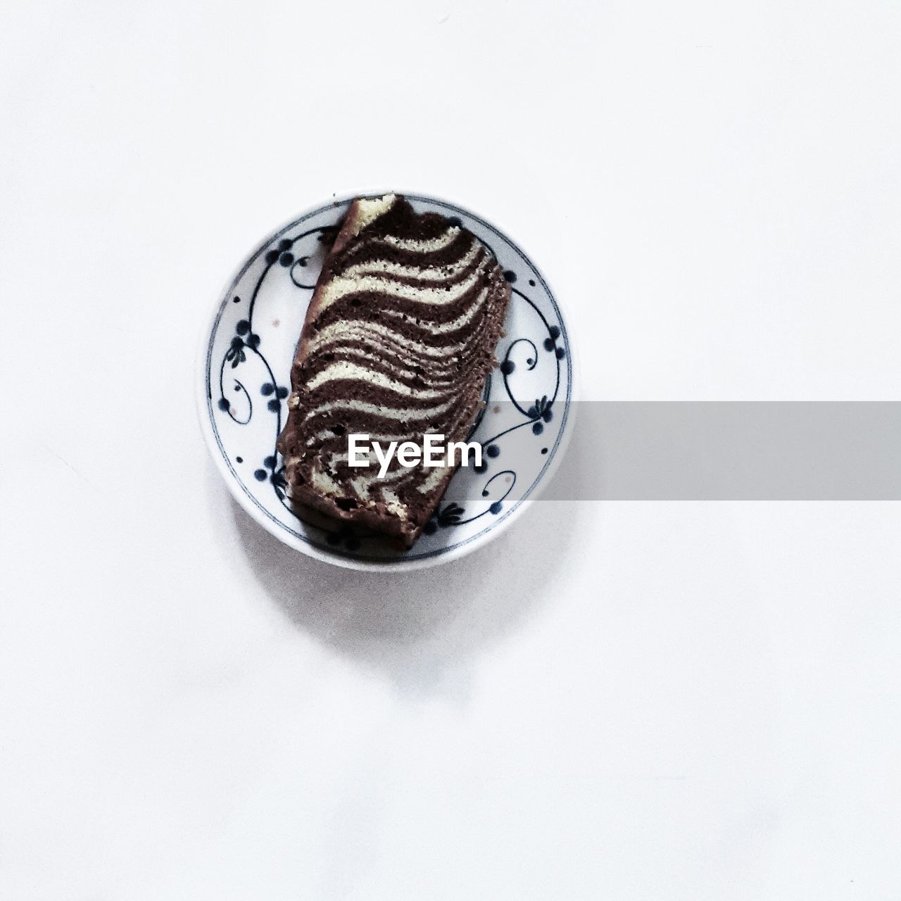 Directly above view of marble cake in plate over white background