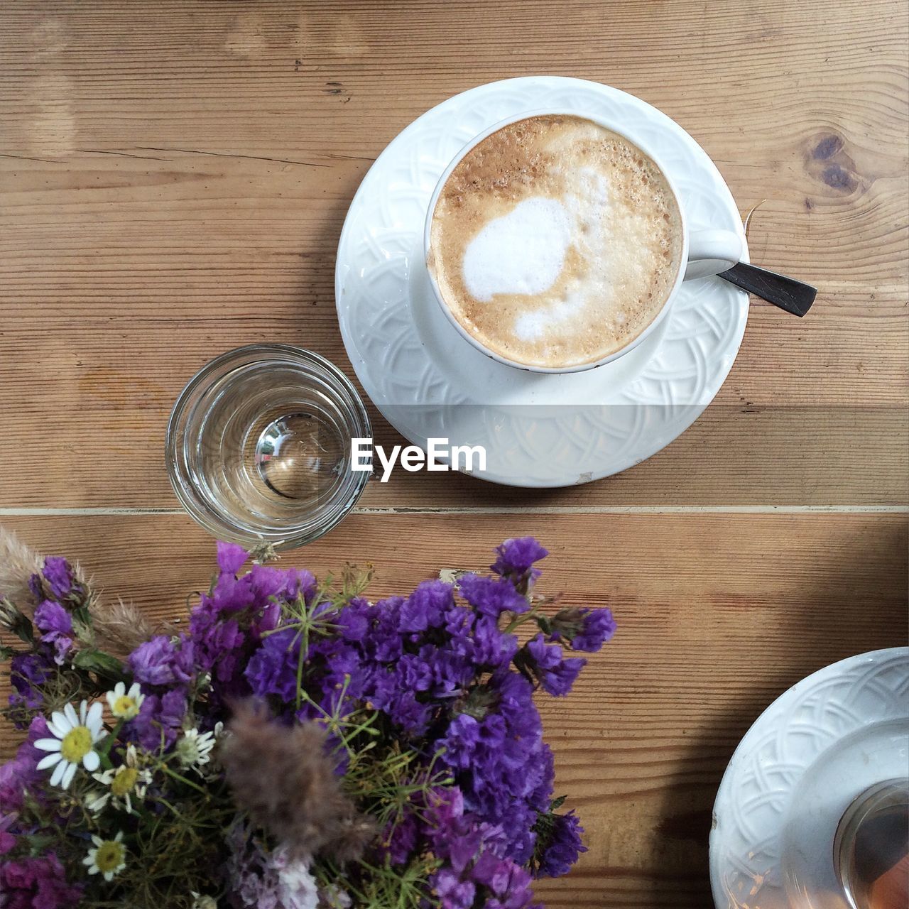 Directly above shot of purple flowers and coffee cup on table