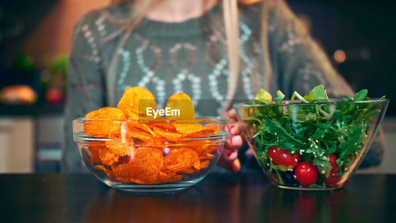 Midsection of woman holding food in jar