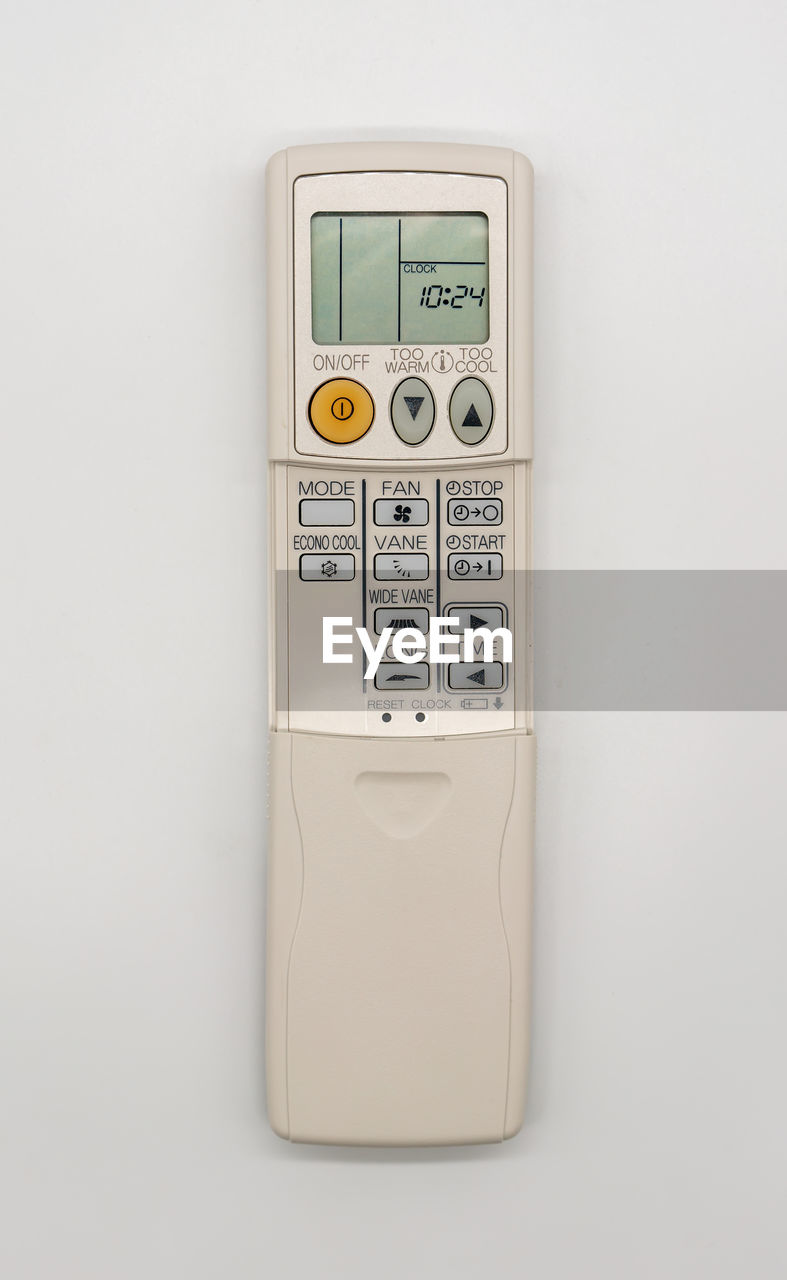 Close-up of air conditioner remote on white background