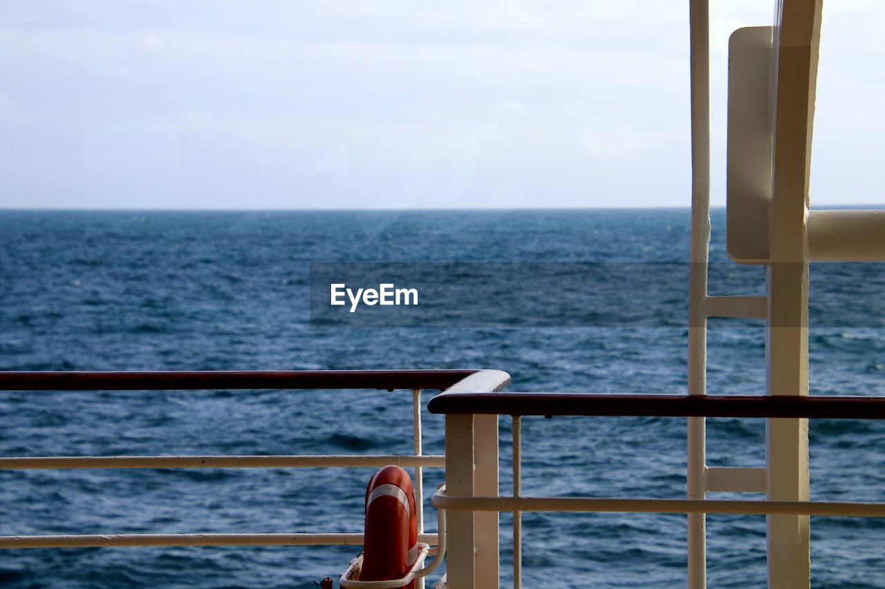 SCENIC VIEW OF SEA AGAINST SKY SEEN FROM RAILING