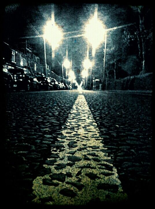 STREET LIGHTS IN ILLUMINATED CITY AT NIGHT