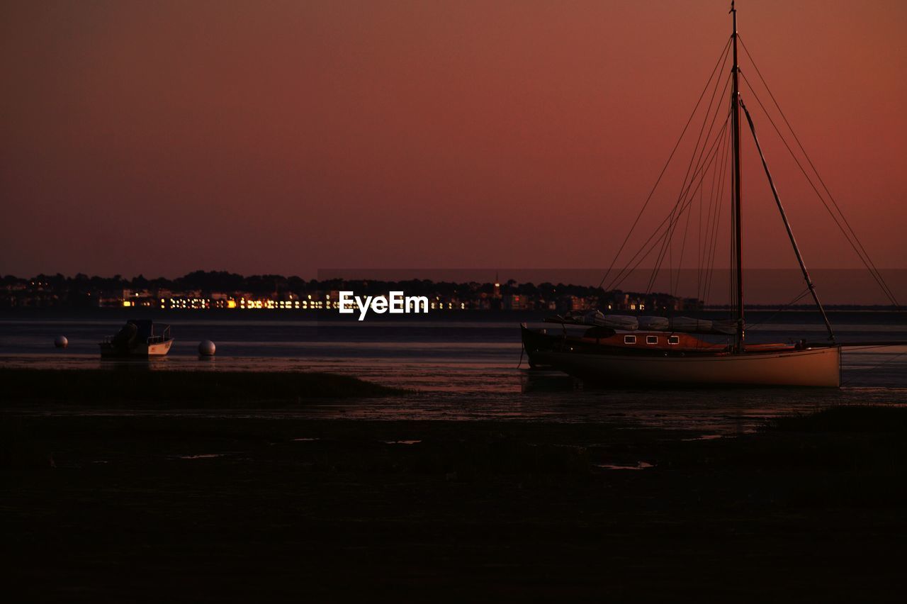 Sailboat on sea against sky during sunset