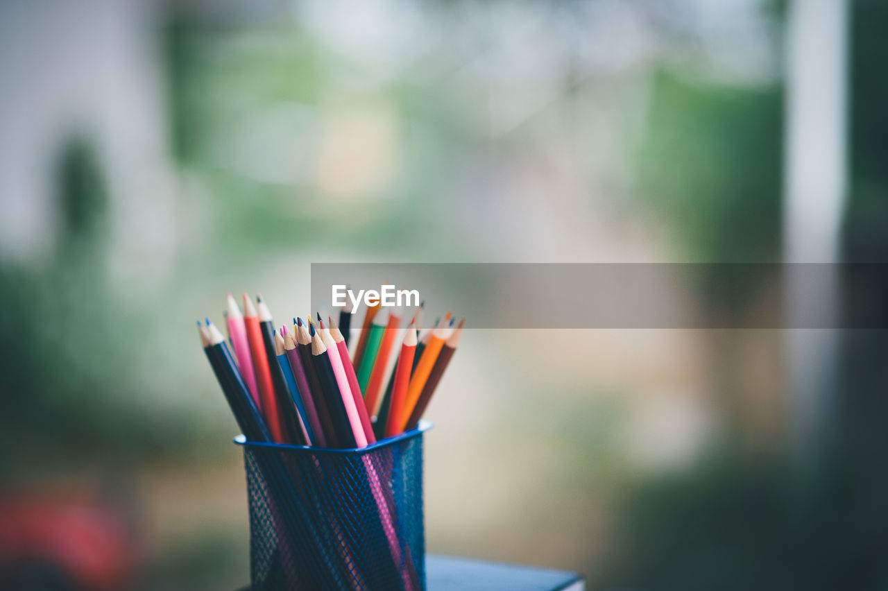 CLOSE-UP OF MULTI COLORED PENCILS IN CONTAINER