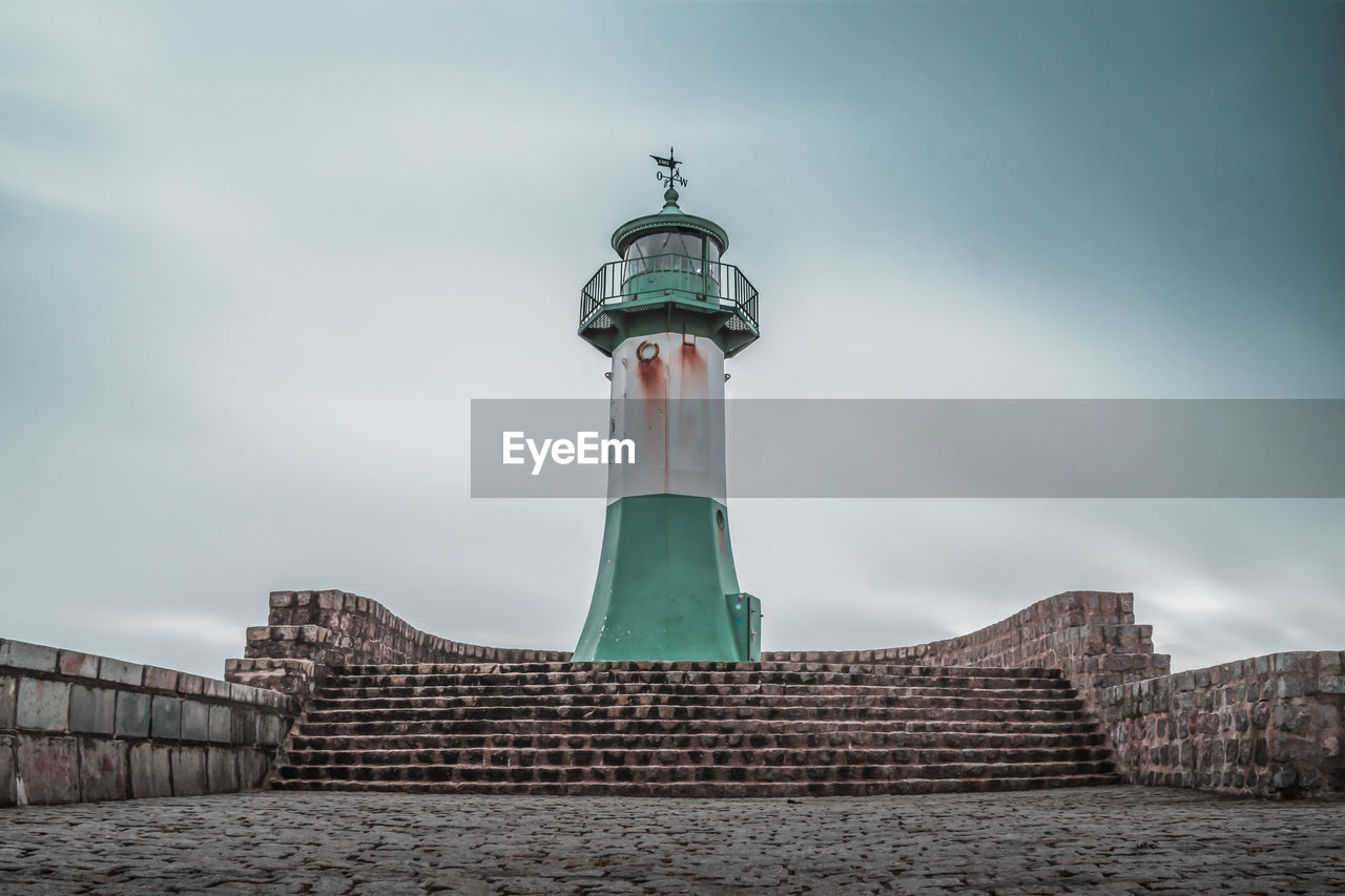 Low angle view of lighthouse against building