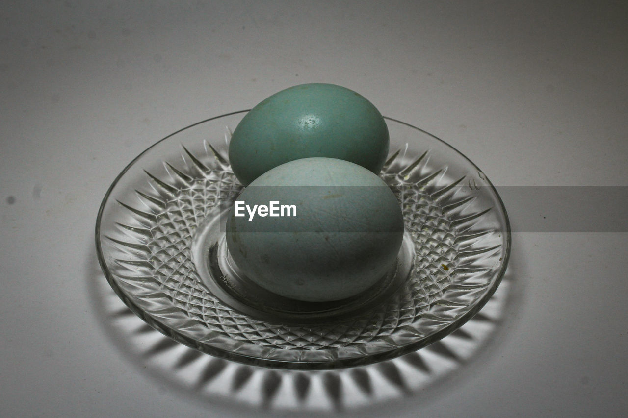 HIGH ANGLE VIEW OF EGG IN PLATE ON TABLE