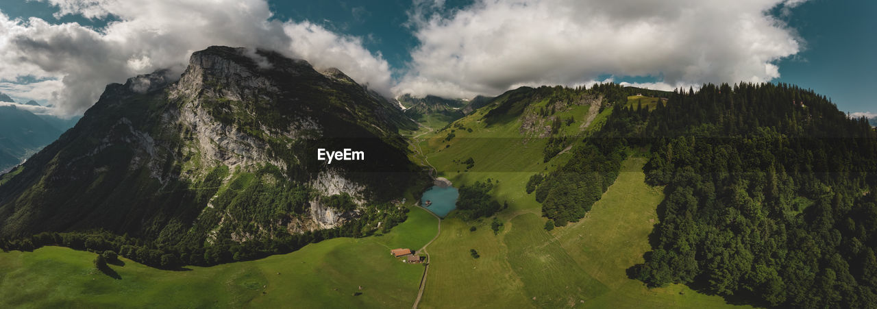 PANORAMIC VIEW OF GREEN LANDSCAPE AGAINST SKY