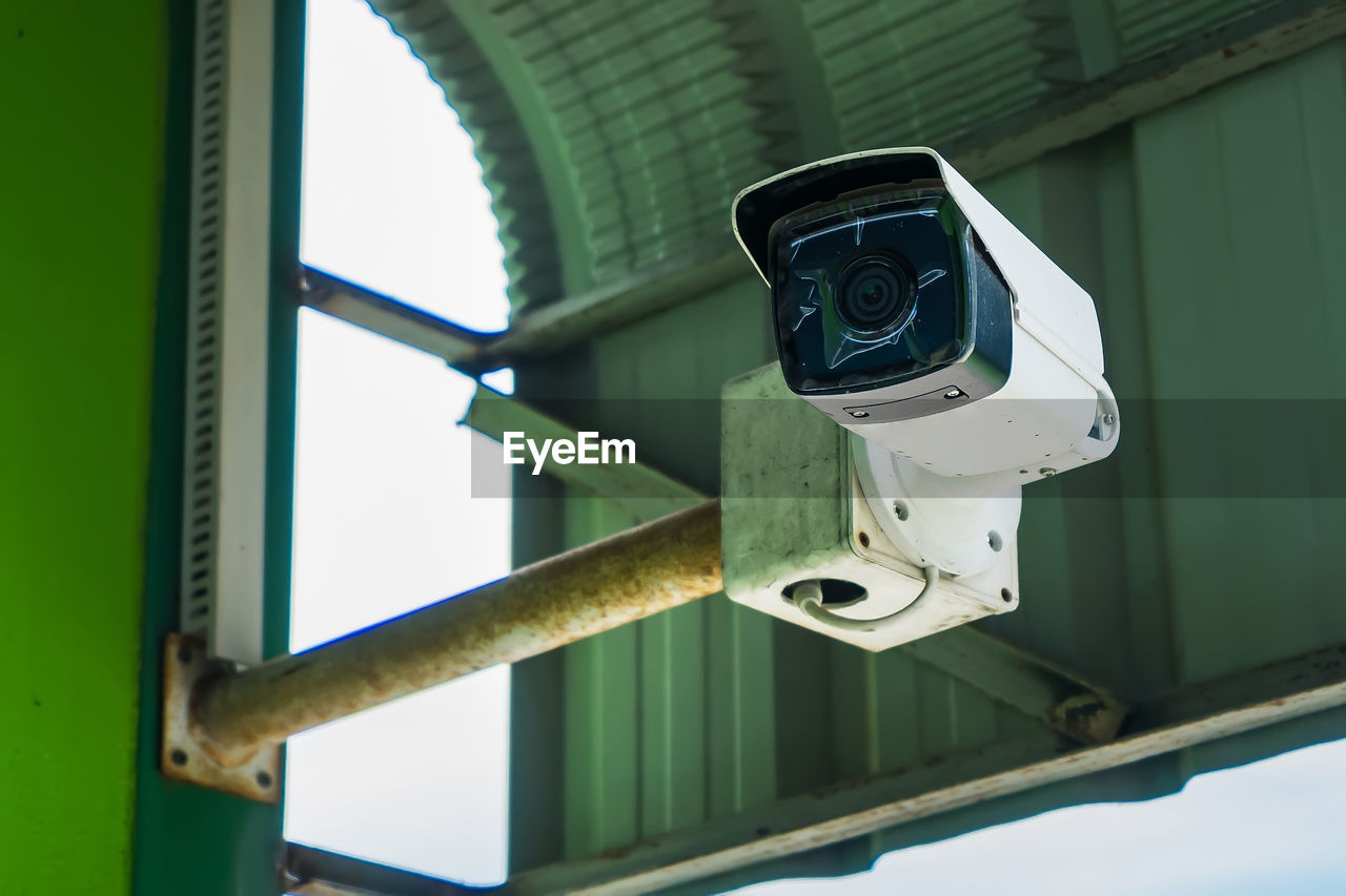 LOW ANGLE VIEW OF CAMERA ON METAL