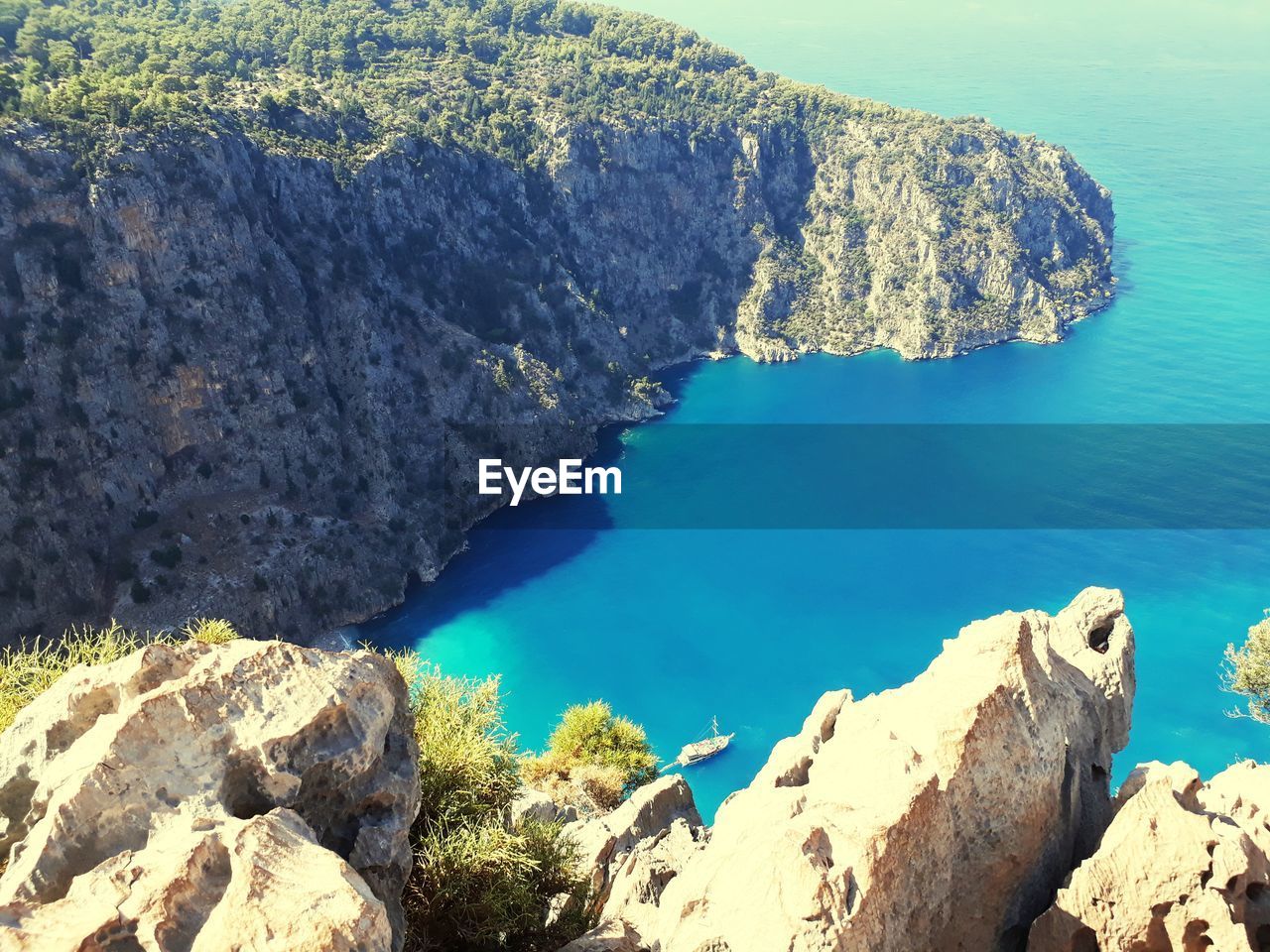 High angle view of rocks on sea shore