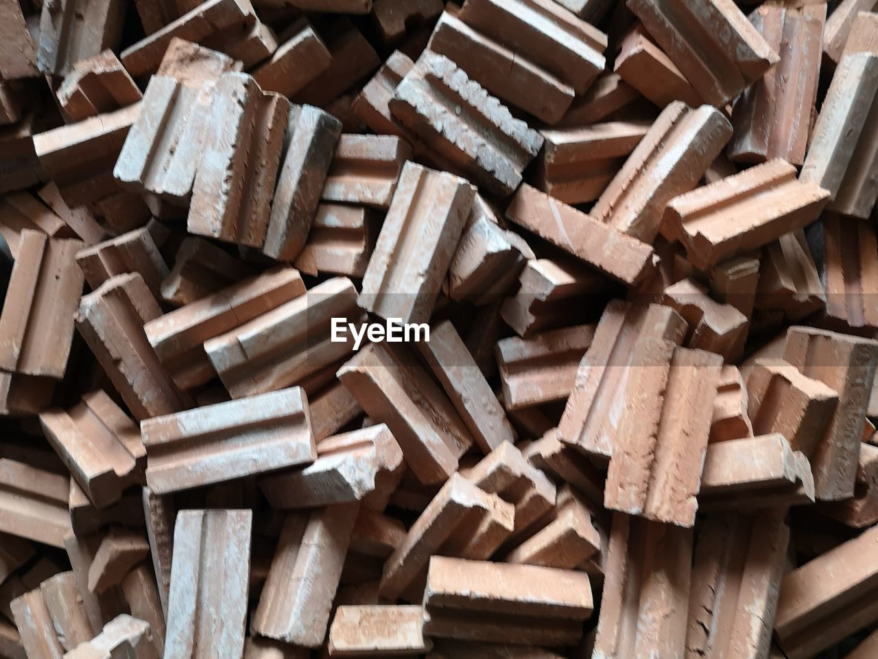 FULL FRAME SHOT OF FIREWOOD STACK OF WOODEN LOGS