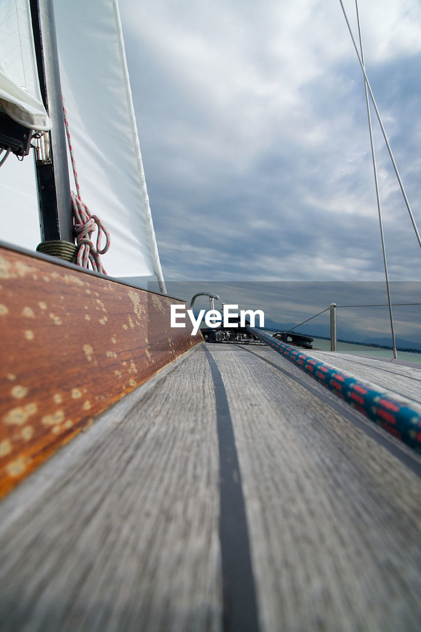 Boat sailing on road against sky