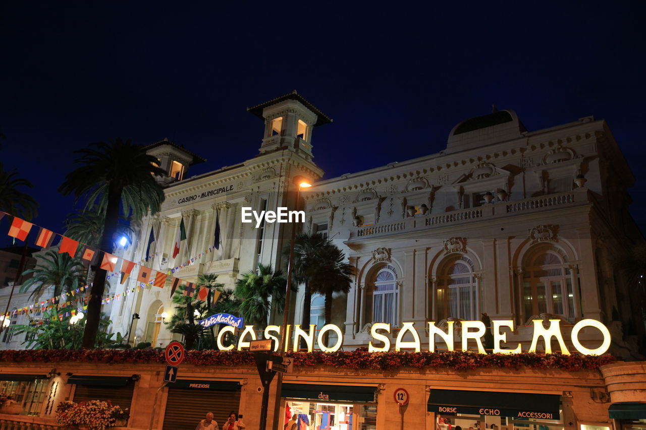 LOW ANGLE VIEW OF ILLUMINATED BUILDING