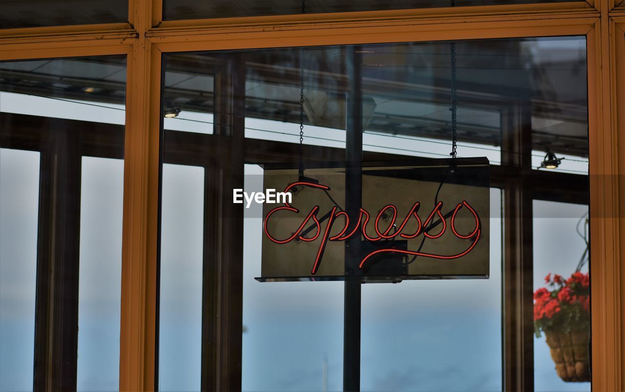 Espresso banner seen through glass door at cafe