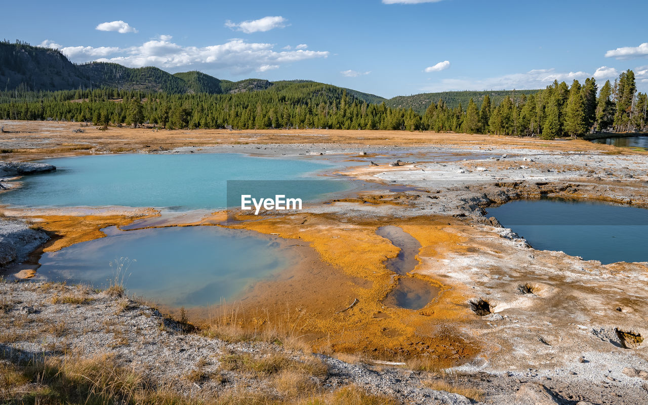 Beautiful black opal pool amidst geothermal landscape at yellowstone park