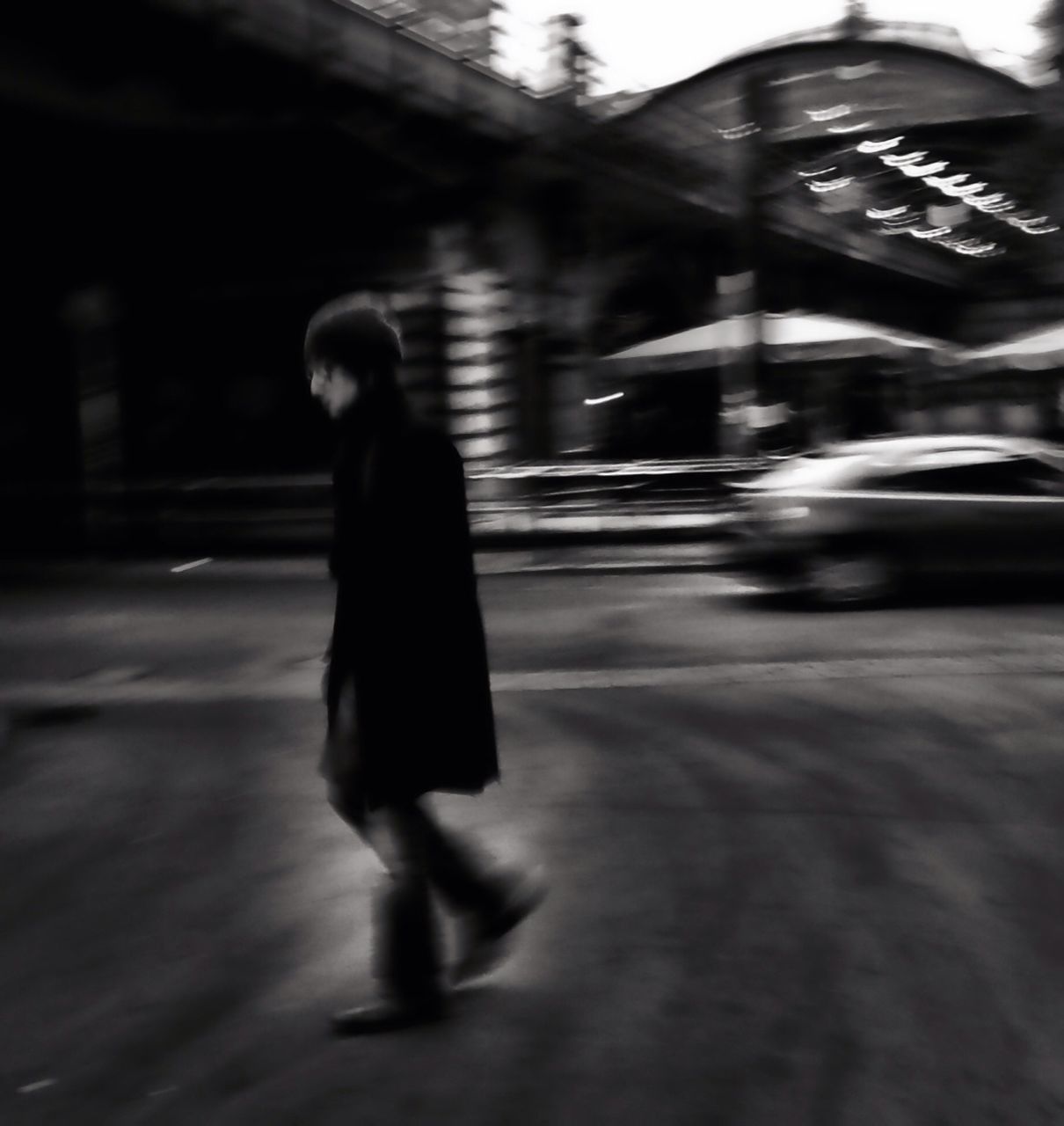 WOMAN WALKING ON ROAD IN CITY