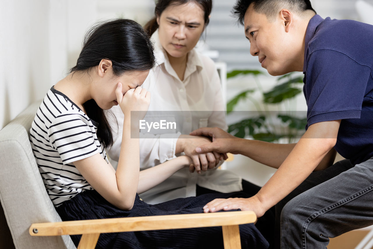 Father consoling daughter