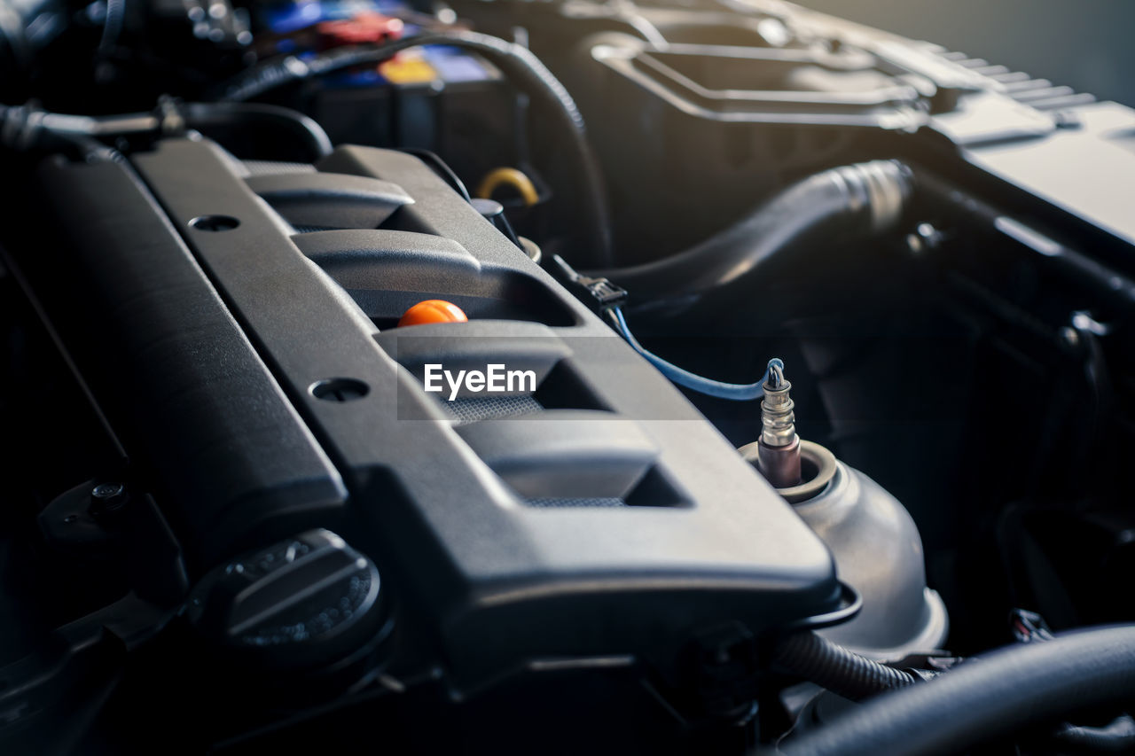 Details of modern car engine with sunlight effect, shallow depth of field