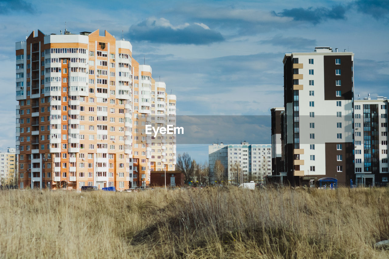 View of buildings against cloudy sky