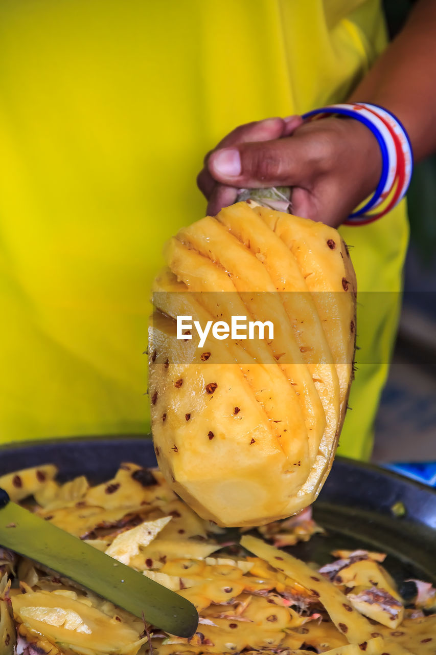 cropped hand of woman holding fruit