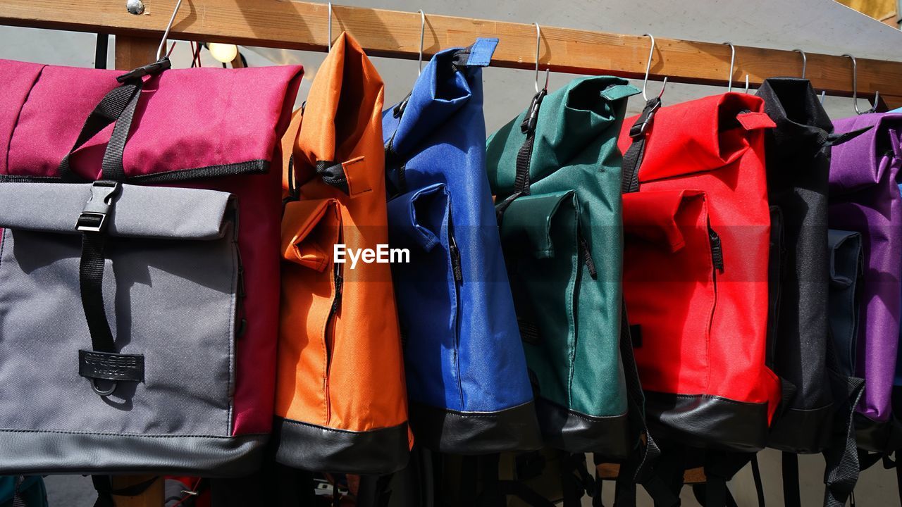 Colorful bags hanging on display 
