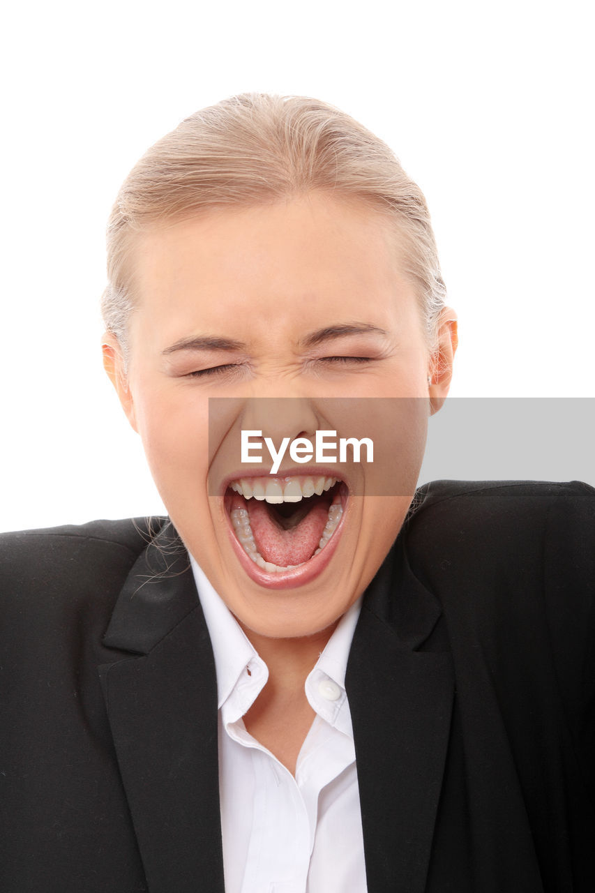 Close-up of businesswoman shouting against white background