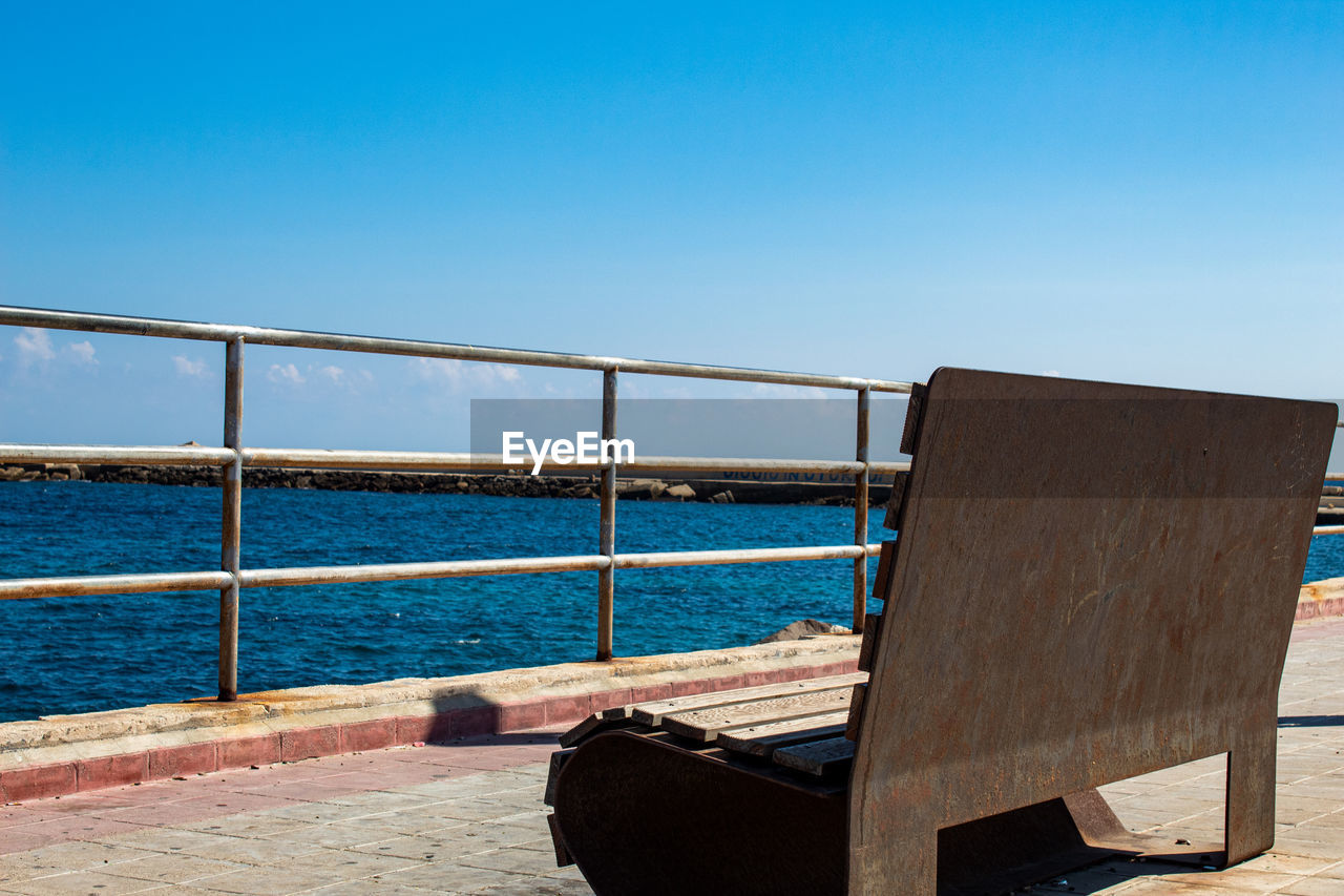 A bench located in siracusa ortigia, overlooking the sea