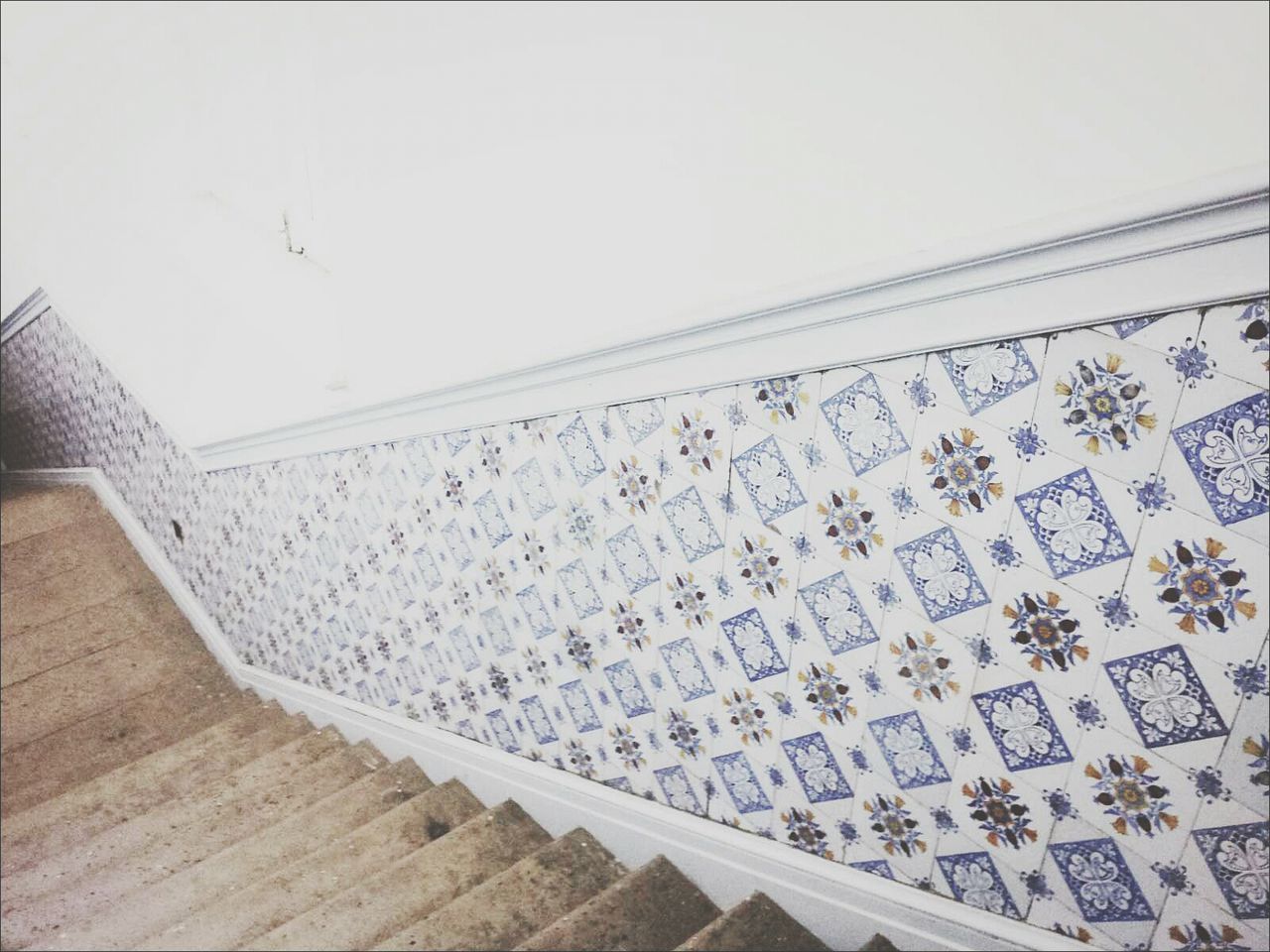 Tiled wall by stairway
