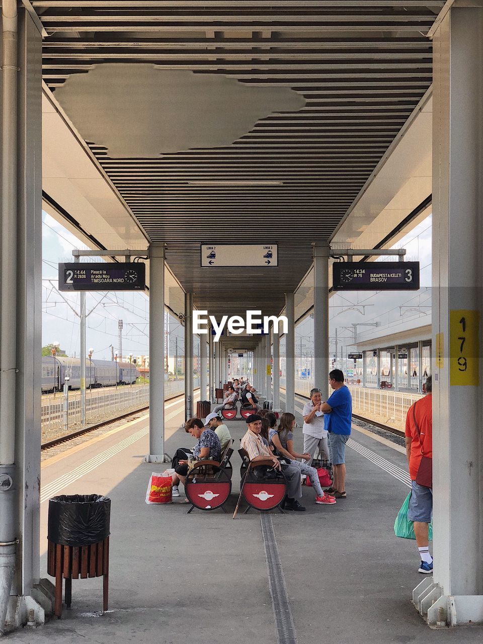 People waiting at railroad station platform