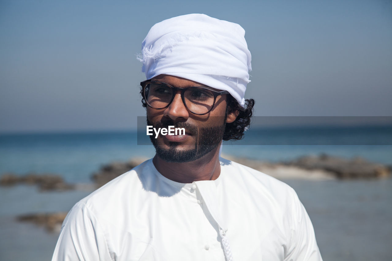 Portrait of man wearing turban on beach