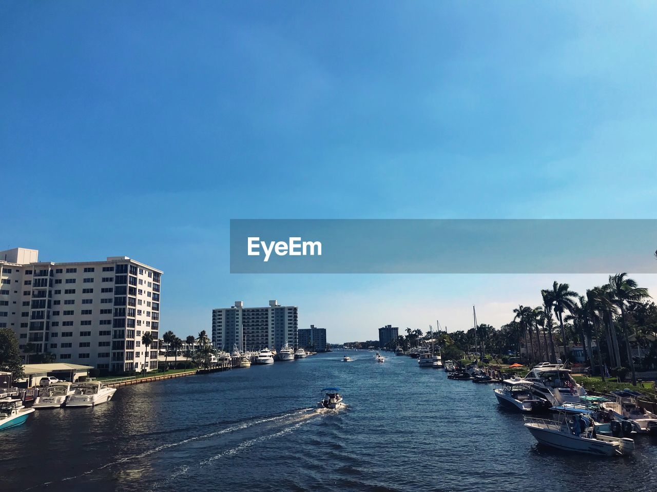 Sea by cityscape against sky