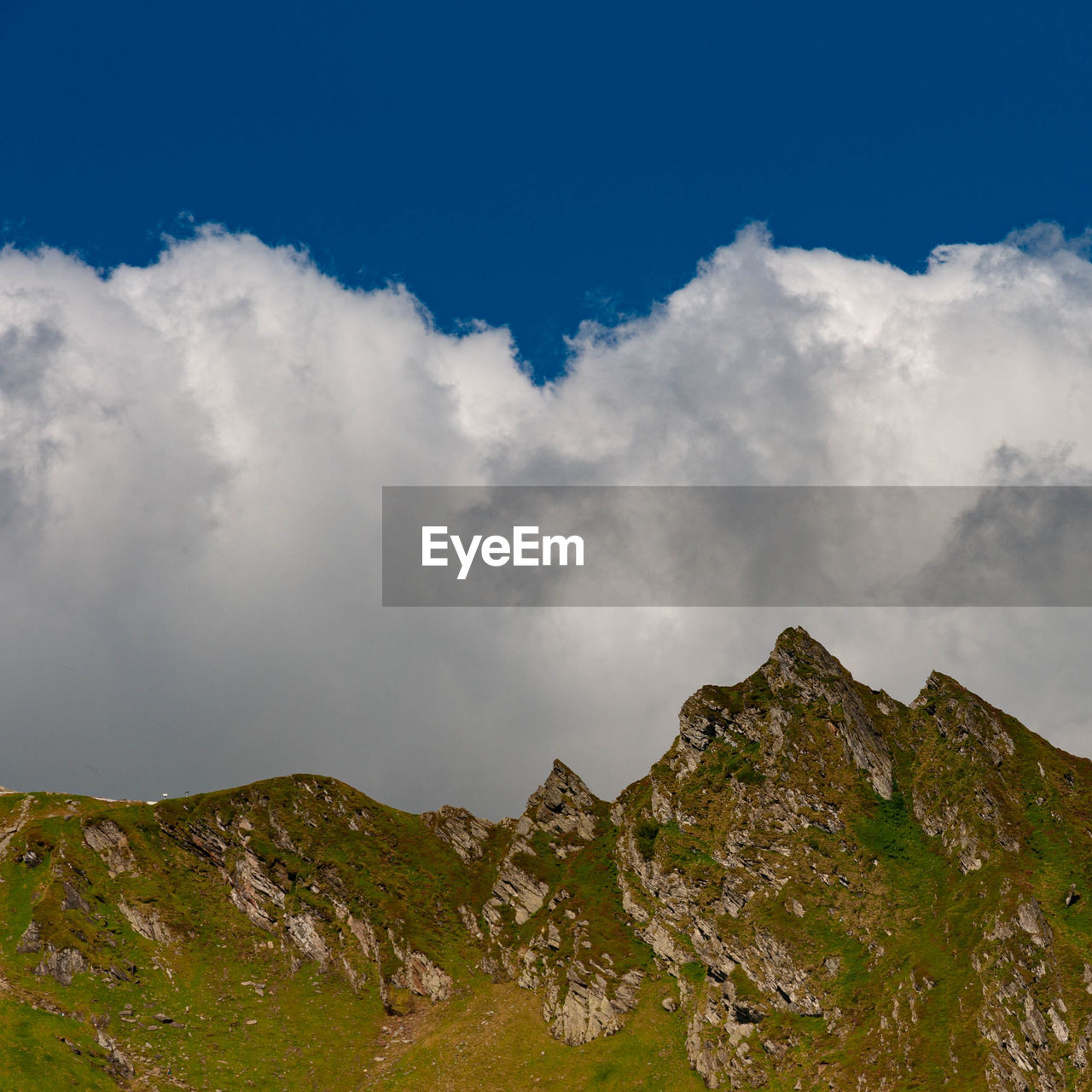 sky, cloud, mountain, environment, nature, mountain range, landscape, scenics - nature, travel, beauty in nature, land, travel destinations, blue, no people, mountain peak, tourism, outdoors, ridge, plateau, trip, cloudscape, rock, vacation, activity, plant, meadow, highland, holiday, summer, social issues, grass, non-urban scene, tranquility, day, leisure activity, fog, high up, architecture, forest