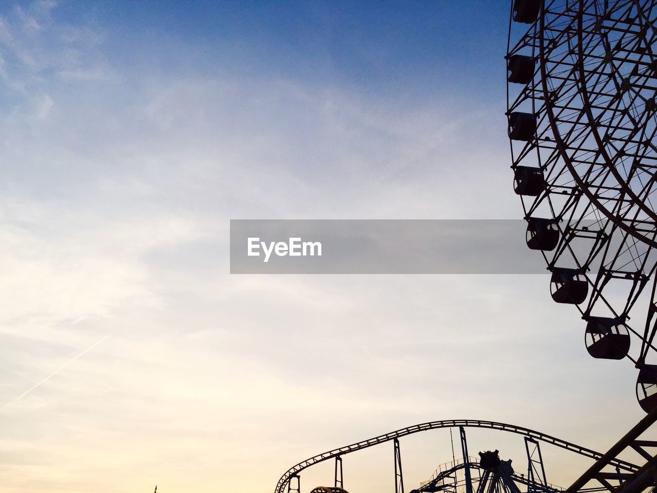 LOW ANGLE VIEW OF AMUSEMENT PARK AGAINST SKY