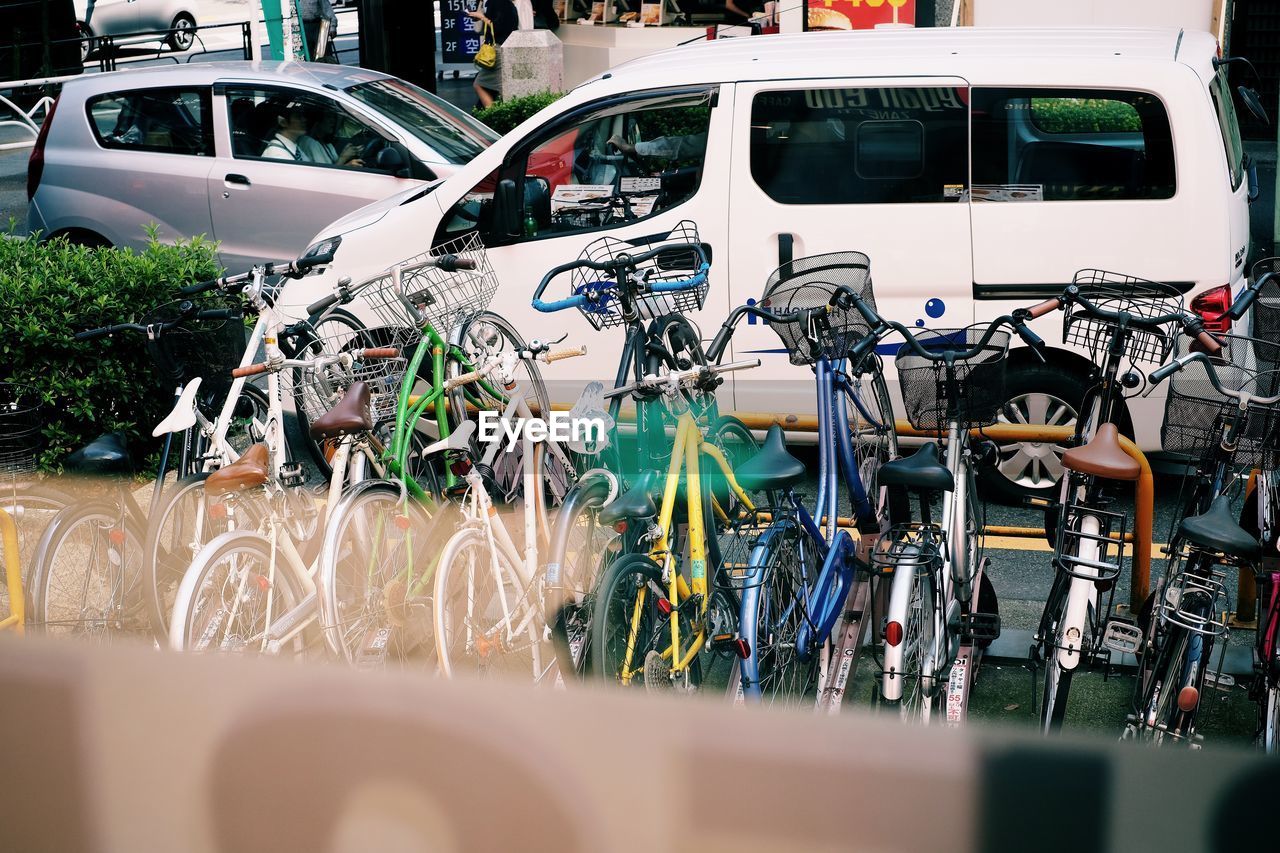 BICYCLE PARKED BY CARS