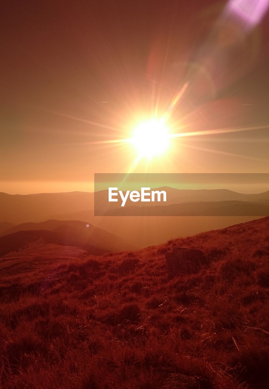 Scenic view of mountains against sky during sunset